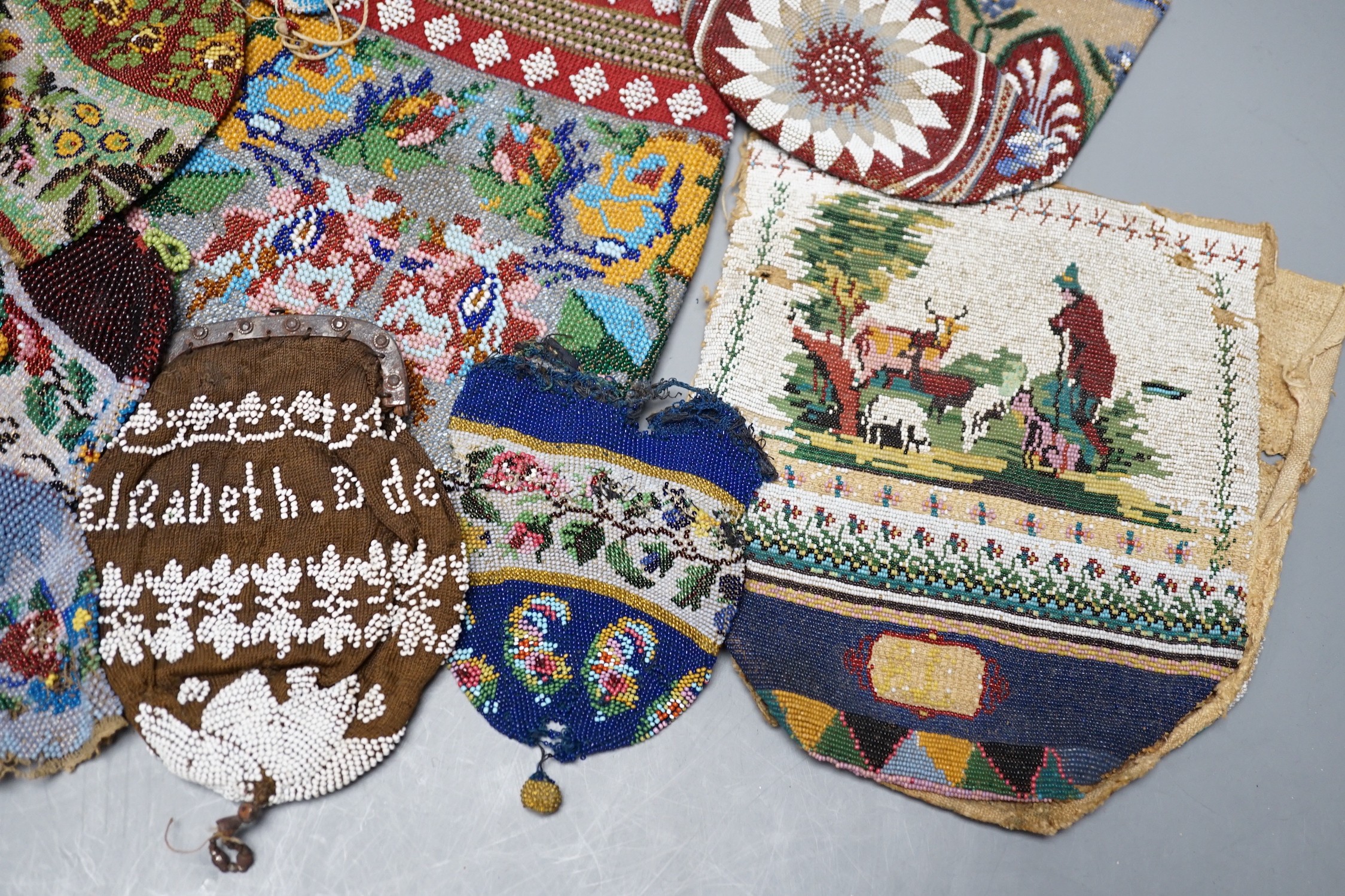 Three Victorian beadwork bags, circa 1860, largest 17cm high, and a collection of eleven smaller reticules and purses